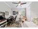 Bedroom featuring a daybed, desk with chair and ceiling fan creating a comfortable workspace at 6816 Sw 95Th Cir, Ocala, FL 34481