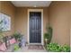 Inviting front door entrance featuring a bench and various decorative plants at 6816 Sw 95Th Cir, Ocala, FL 34481