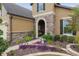 The front entrance has a stone archway, paver walkway, and colorful landscaping at 6816 Sw 95Th Cir, Ocala, FL 34481