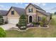 Charming two-story home with stone accents, arched entryway, and meticulously landscaped front yard at 6816 Sw 95Th Cir, Ocala, FL 34481