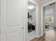 Hallway view with laundry room and bedroom featuring wood floors and natural light at 6816 Sw 95Th Cir, Ocala, FL 34481