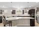 Kitchen with stainless steel appliances, gray countertops, lots of cabinets and a breakfast bar with seating at 6816 Sw 95Th Cir, Ocala, FL 34481