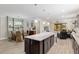 Open kitchen layout showcasing an island, breakfast area, and living room in a well-lit space at 6816 Sw 95Th Cir, Ocala, FL 34481