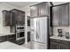 Kitchen with stainless steel appliances, granite countertops, dark cabinets, and bar area at 6816 Sw 95Th Cir, Ocala, FL 34481