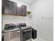 Laundry room with front load washer and dryer and cabinets for storage at 6816 Sw 95Th Cir, Ocala, FL 34481