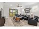 Elegant living room with dark leather furniture and sliding glass doors to the backyard at 6816 Sw 95Th Cir, Ocala, FL 34481