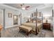 Elegant main bedroom featuring a four-poster bed, ceiling fan, sitting bench, and decorative details at 6816 Sw 95Th Cir, Ocala, FL 34481