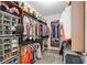 Organized walk-in closet with shelving, hanging racks, and ample storage space for clothes and accessories at 6816 Sw 95Th Cir, Ocala, FL 34481