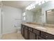 Bathroom featuring a double vanity, granite countertop, tile flooring, and glass-enclosed shower at 7249 Sw 93Rd Ave, Ocala, FL 34481