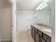 Bathroom featuring a double vanity, granite countertop, and tile flooring at 7249 Sw 93Rd Ave, Ocala, FL 34481