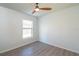 Bedroom featuring a ceiling fan, wood floors, and a window providing natural light at 7249 Sw 93Rd Ave, Ocala, FL 34481