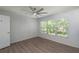 Bright bedroom with a ceiling fan, wood floors, and a window providing natural light at 7249 Sw 93Rd Ave, Ocala, FL 34481