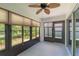Enclosed patio with a ceiling fan, tinted windows, and access to natural light at 7249 Sw 93Rd Ave, Ocala, FL 34481