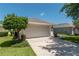 Two-car garage with a clean driveway and mature landscaping at 7249 Sw 93Rd Ave, Ocala, FL 34481