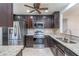 Elegant kitchen featuring dark wood cabinets, stainless steel appliances and granite countertops at 7249 Sw 93Rd Ave, Ocala, FL 34481