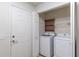 Laundry area with newer washer/dryer units and shelving for convenient storage at 7249 Sw 93Rd Ave, Ocala, FL 34481