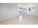 Open living area with a ceiling fan, tile flooring, and views of the kitchen and front entry at 7249 Sw 93Rd Ave, Ocala, FL 34481