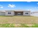 Back exterior of home showing backyard and covered patio space at 7827 Sw 56Th Pl, Ocala, FL 34474
