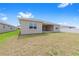 Rear exterior showcasing the back patio of the home and green backyard area at 7827 Sw 56Th Pl, Ocala, FL 34474