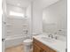 Bright bathroom featuring a tub-shower combo, wood vanity and modern fixtures at 7827 Sw 56Th Pl, Ocala, FL 34474