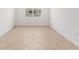 Bright bedroom with neutral tile flooring and a window allowing natural light at 7827 Sw 56Th Pl, Ocala, FL 34474