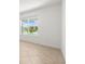 Bright bedroom features a view of neighborhood homes through the large window at 7827 Sw 56Th Pl, Ocala, FL 34474