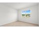 Bright bedroom featuring tile floors and a window offering natural light and neighborhood views at 7827 Sw 56Th Pl, Ocala, FL 34474
