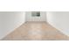 Bright empty room with tile floors, a window, and fresh white paint at 7827 Sw 56Th Pl, Ocala, FL 34474