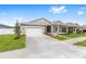 Inviting single-story home with a two-car garage, covered porch and landscaped front yard at 7827 Sw 56Th Pl, Ocala, FL 34474