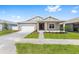 Beautiful one-story home with a manicured lawn, a two-car garage, and a welcoming covered porch at 7827 Sw 56Th Pl, Ocala, FL 34474