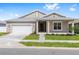 Inviting single-story home with a two-car garage, covered porch, and neatly landscaped front yard at 7827 Sw 56Th Pl, Ocala, FL 34474