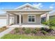 Welcoming front porch featuring sturdy columns and manicured landscaping at 7827 Sw 56Th Pl, Ocala, FL 34474
