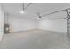 Spacious two car garage with a water heater, white walls, concrete floor and an automatic garage door opener at 7827 Sw 56Th Pl, Ocala, FL 34474