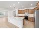 Well-lit kitchen with stainless steel appliances and an island overlooking the living space at 7827 Sw 56Th Pl, Ocala, FL 34474