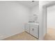 Bright laundry room features a white washer and dryer, with tile floors and a wire rack for storage at 7827 Sw 56Th Pl, Ocala, FL 34474