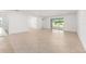 Bright open-plan living space with tiled floors and sliding glass doors to backyard at 7827 Sw 56Th Pl, Ocala, FL 34474