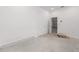 White room with a closet and a view into the garage area; concrete floors and white walls at 7827 Sw 56Th Pl, Ocala, FL 34474