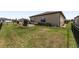 Large backyard features green lawn, plants along the perimeter, and a black metal fence surrounding the property at 9063 Sw 59Th Lane Rd, Ocala, FL 34481