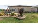 The backyard features a manicured lawn, landscaping with shrubs, and a patio area with furniture at 9063 Sw 59Th Lane Rd, Ocala, FL 34481