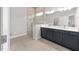 Modern bathroom featuring a glass enclosed shower, double sinks, and tile flooring at 9063 Sw 59Th Lane Rd, Ocala, FL 34481