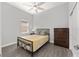 Bedroom featuring wood floors, ceiling fan, dresser and window for natural light at 9063 Sw 59Th Lane Rd, Ocala, FL 34481