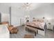 Bright bedroom featuring wood floors, ceiling fan, dresser and floral bedding set at 9063 Sw 59Th Lane Rd, Ocala, FL 34481