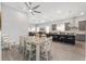 Bright dining area flows into kitchen and living spaces, featuring a modern ceiling fan at 9063 Sw 59Th Lane Rd, Ocala, FL 34481