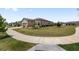 Charming one-story home with a lush green lawn, beautifully landscaped flower beds, and a paved driveway at 9063 Sw 59Th Lane Rd, Ocala, FL 34481
