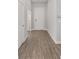 Hallway featuring wood-look flooring and ample natural light streaming in from a nearby door at 9063 Sw 59Th Lane Rd, Ocala, FL 34481