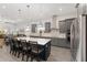 Modern kitchen features a large island with bar seating, stainless steel appliances, and stylish cabinets at 9063 Sw 59Th Lane Rd, Ocala, FL 34481