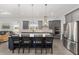 Modern kitchen showcasing a large island, stainless steel appliances, and gray cabinetry at 9063 Sw 59Th Lane Rd, Ocala, FL 34481