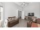 Bright living room featuring a ceiling fan and seamlessly connected access to another room at 9063 Sw 59Th Lane Rd, Ocala, FL 34481