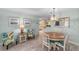 Bright dining area featuring a round table, tropical print chairs, and stylish decor at 9333 Sw 97Th Pl # C, Ocala, FL 34481