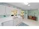White kitchen features modern appliances and ample counter space at 9333 Sw 97Th Pl # C, Ocala, FL 34481